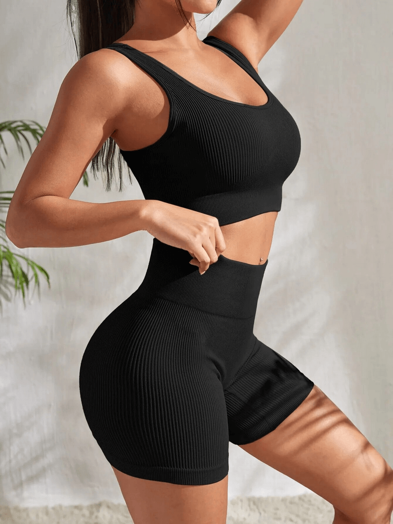 Seamless ribbed yoga crop top and high waist shorts set in black, quick-dry and breathable, designed for women, offering comfort and support.